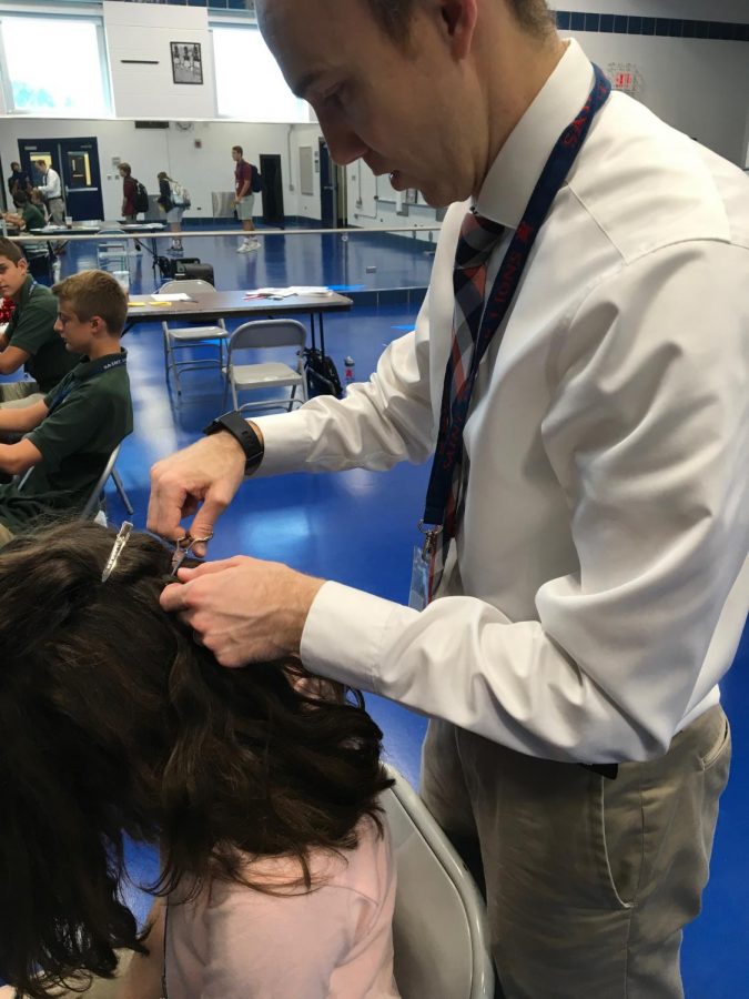 Dean Fuja cuts a students hair for drug testing.
