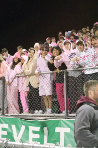 Students at a home football game dress in the pink out theme. Opinions vary as to which themes are socially appropriate.                 
